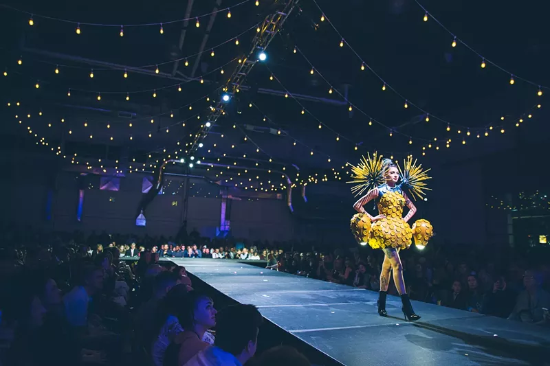 Image: woman wearing a yellow dress on a runway