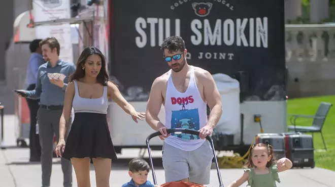 Family walks in park during summer