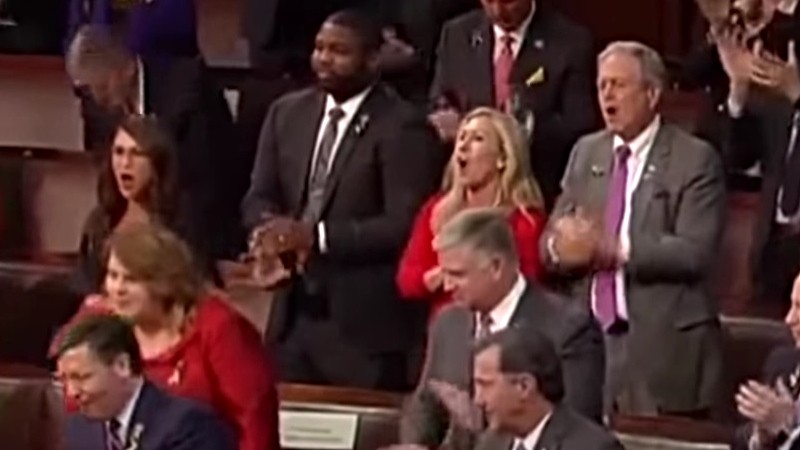 Representative Lauren Boebert, left center, and fellow rep Marjorie Taylor Greene, center, delivering an anti-Joe Biden chant during the March 1 State of the Union address.