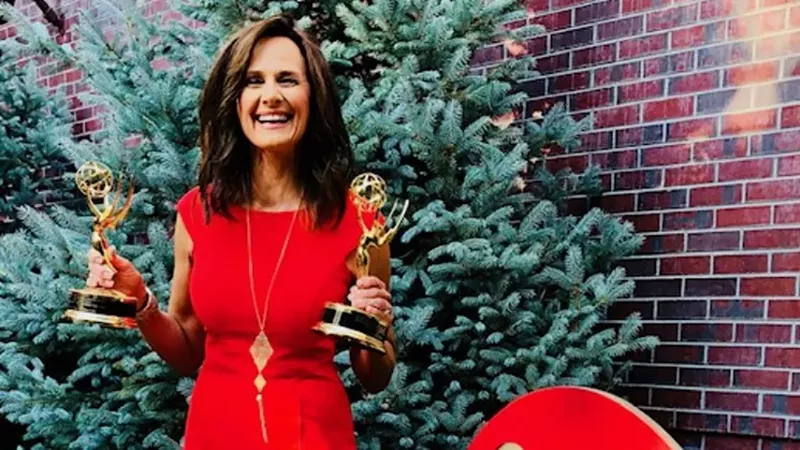 Image: Kathy Sabine, longtime 9News meteorologist, with two of her numerous Emmy Awards.