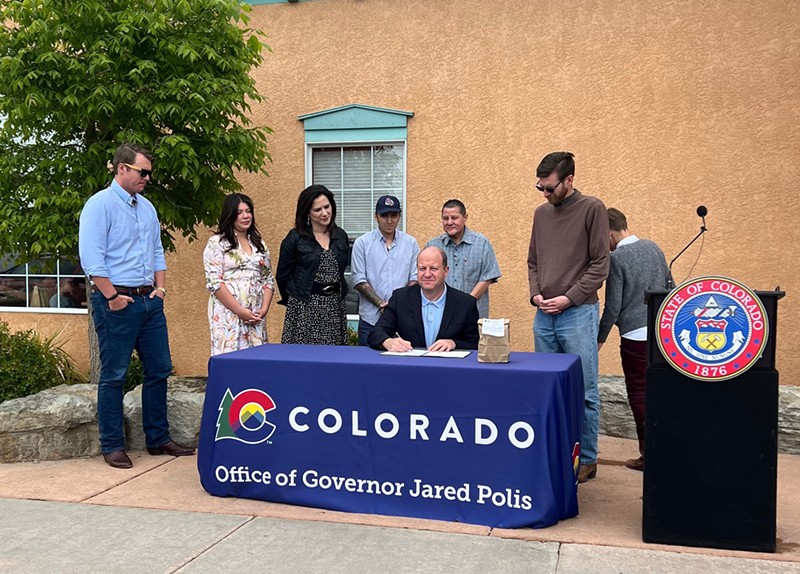 Governor Jared Polis made to-go booze permanent at a bill signing in Pueblo on May 10.