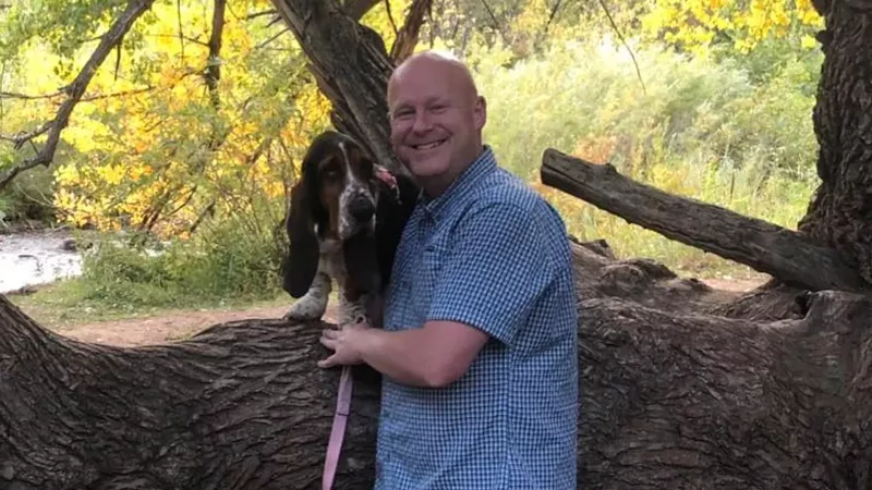 Image: Chris Spears striking a pose alongside his basset hound, Rosie Belle.
