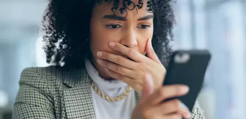 Image: woman gasping while reading media