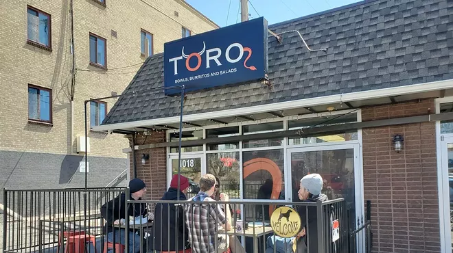 people eating outside on restaurant patio.