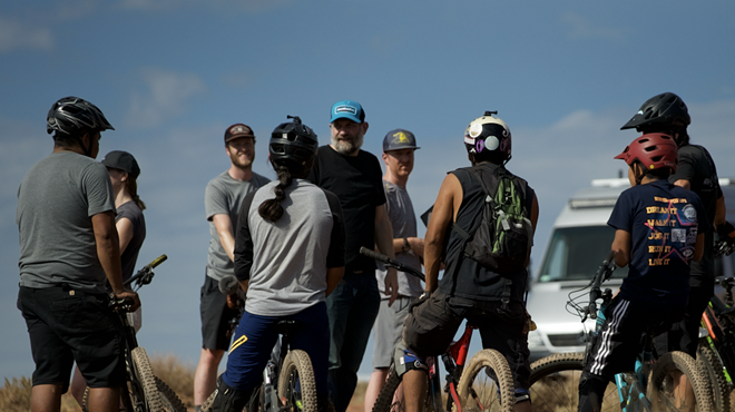People on mountain bikes talking to film director T.C. Johnstone in Navajo Nation.