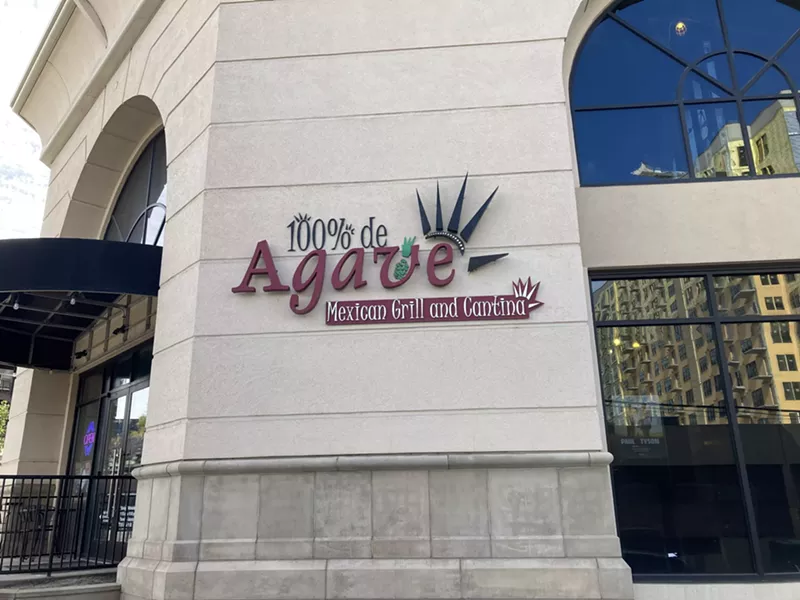 Image: "100% de agave" sign on the side of a building
