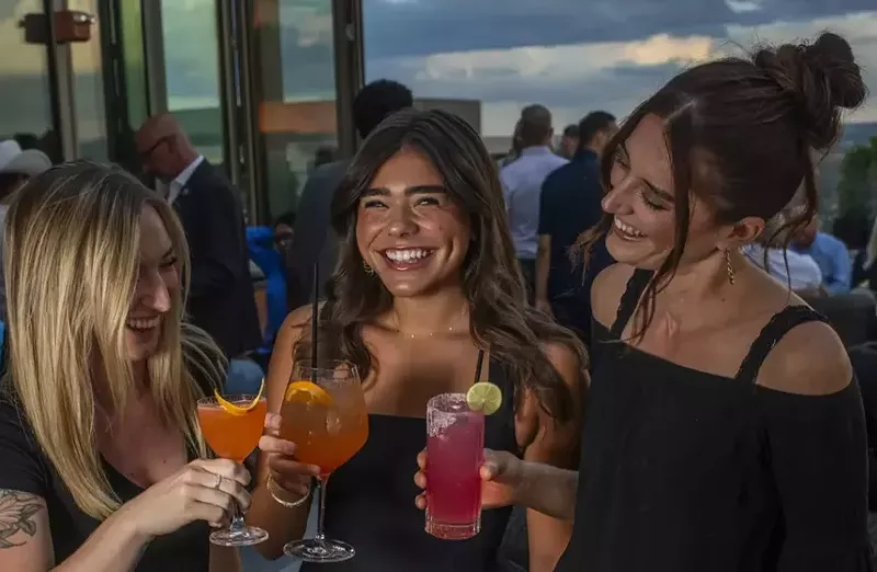 Image: three women on rooftop deck