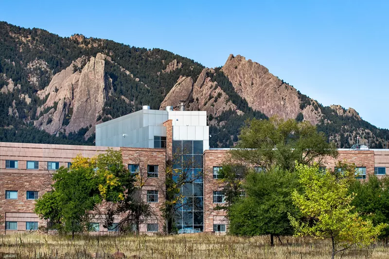 Image: brick building against mountains, blue sky