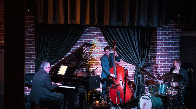Jazz musicians perform onstage.