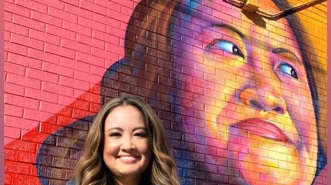 woman in front of mural portrait