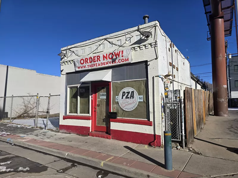 Image: exterior of a small white and red building