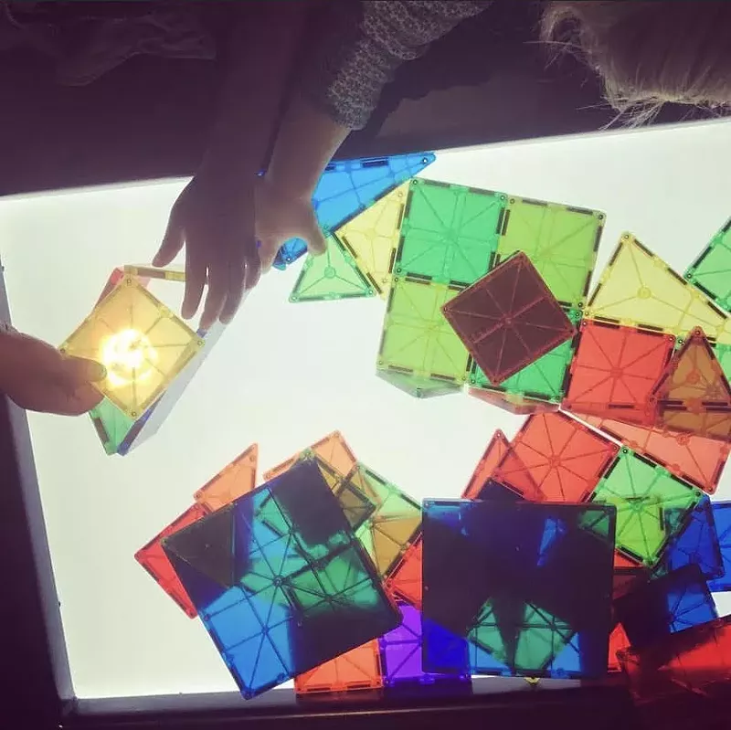Image: hands playing with glass