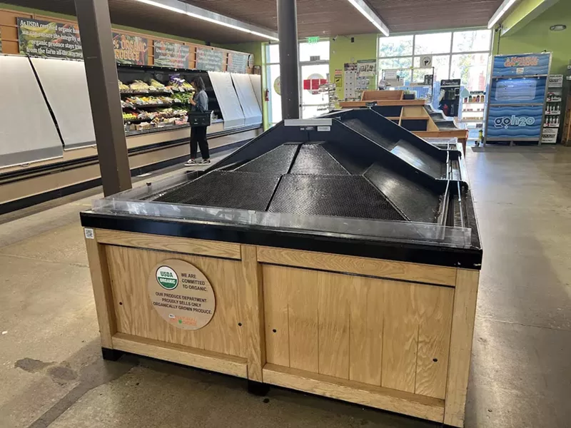 Image: empty shelves at grocer store.