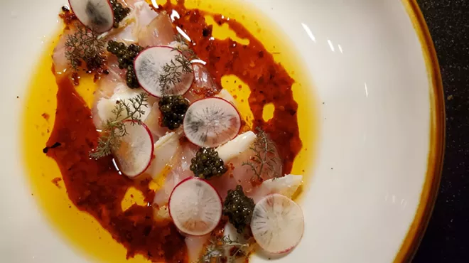 kampachi on a plate with sliced radishes