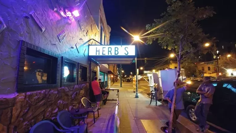 Image: exterior of a dive bar in denver at night