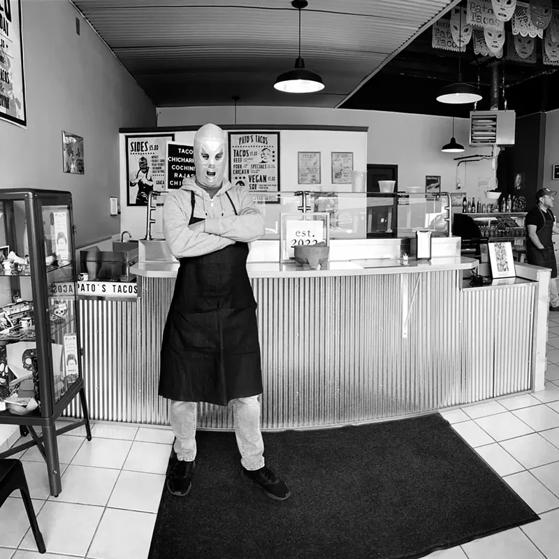 Image: Pato helping customers smile in lucha libre gear.