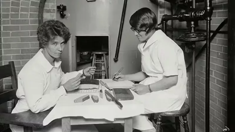 Image: two female students cooking