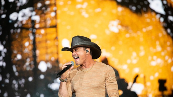 man in cowboy hat singing