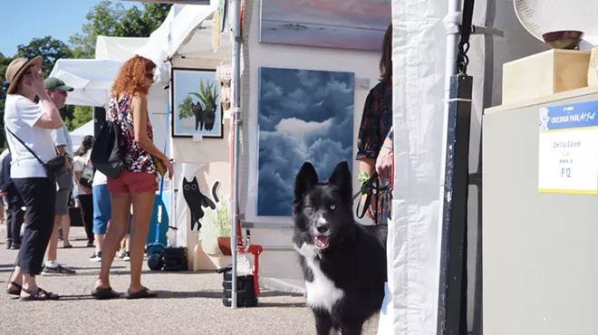a dog peeks out of a booth