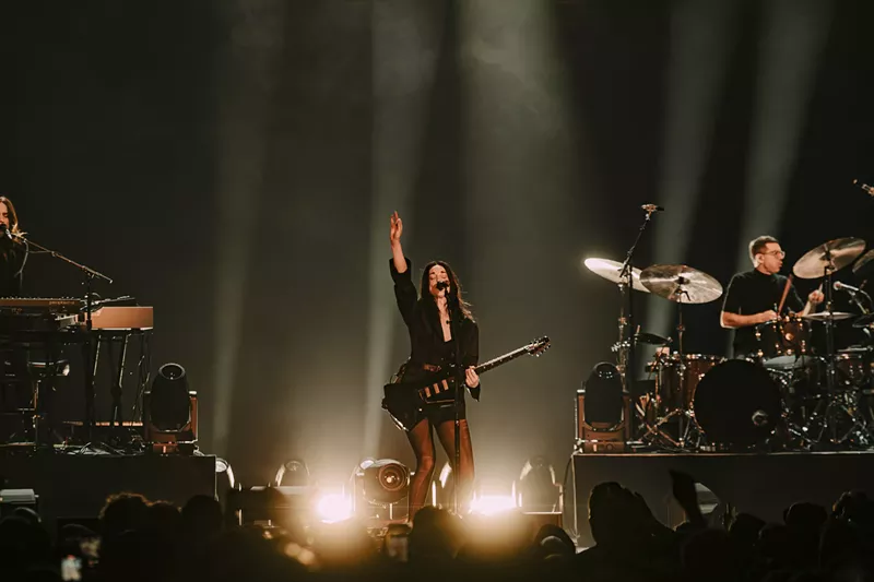 Image: St. Vincent performing on stage at the Mission Ballroom in Denver, Colorado.