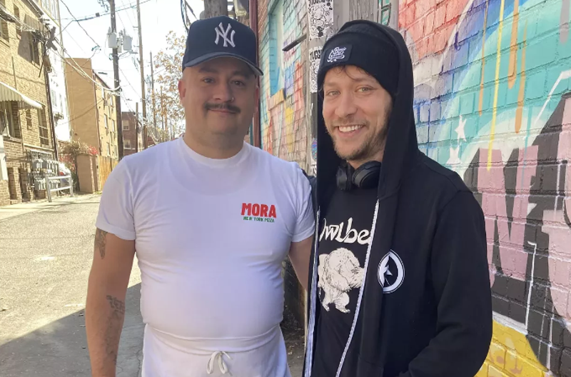 Image: two men standing in an alley