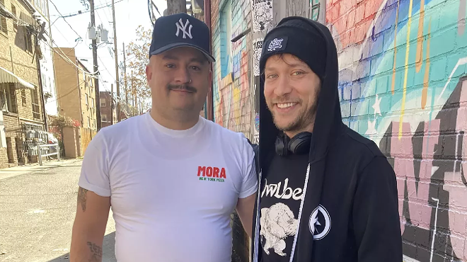 two men standing in an alley