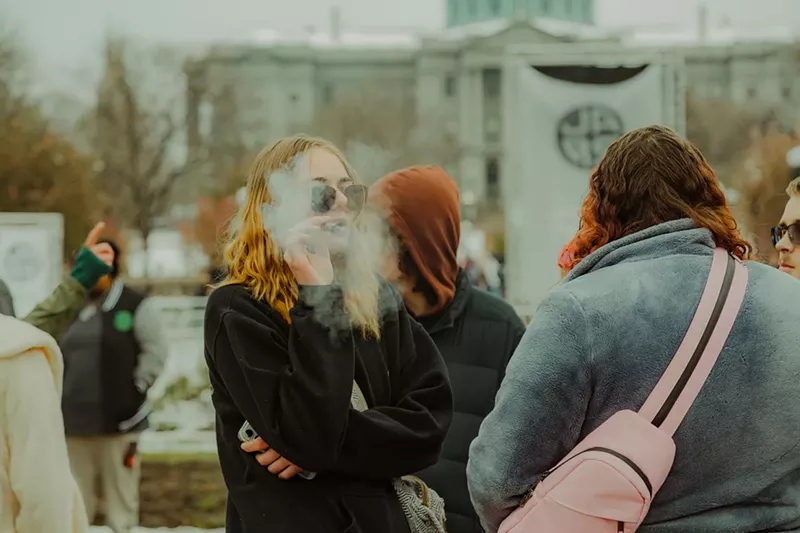 Image: Woman smokes a joint at Denver 420 festival