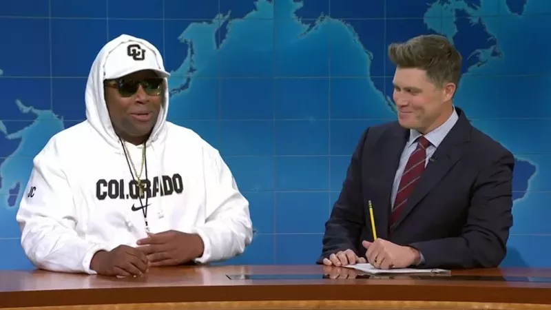 Image: man in white hoodie with interviewer