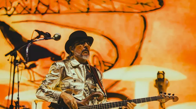 Les Claypool performing on stage at Red Rocks.