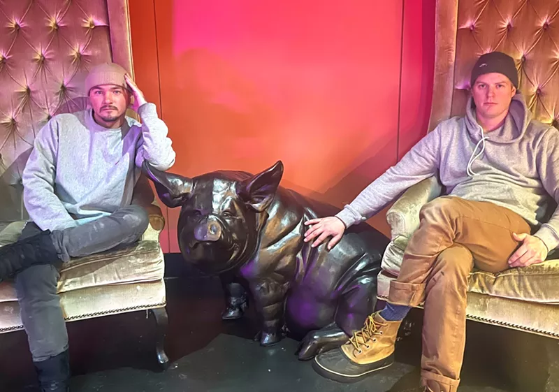 Image: Josh Schmitz and Matt Haberman with Disco Pig's mascot “Alan,” who greets you when you walk in.