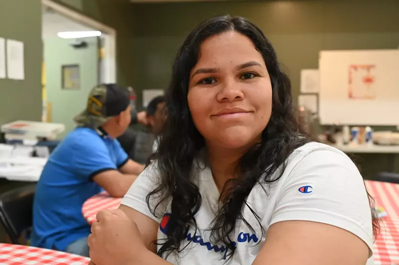 Image: A Venezuelan migrant woman smiles.