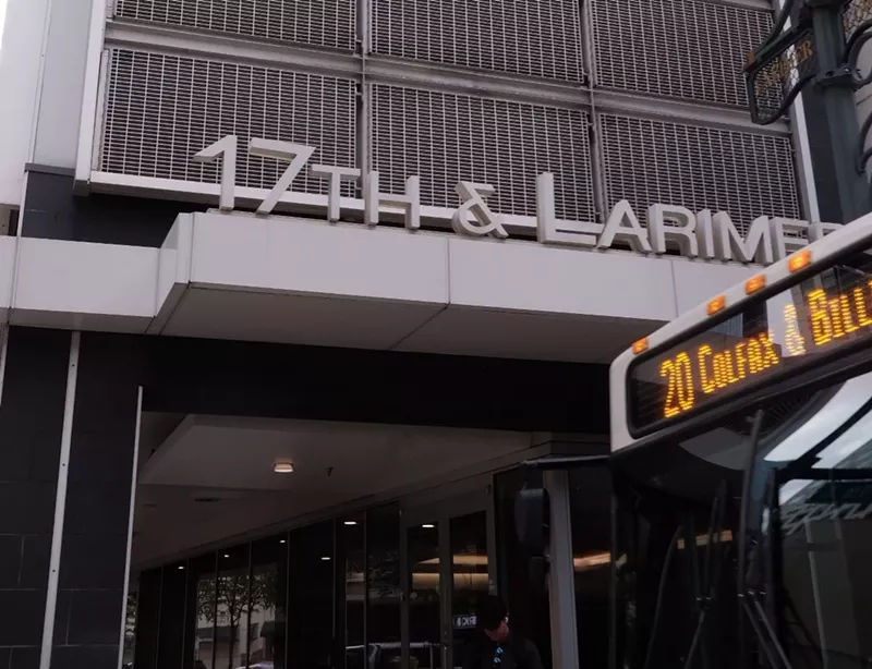Image: bus and sign outside building