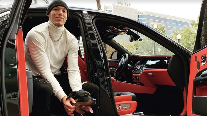 Denver Nuggets star Aaron Gordon posing with his dog.