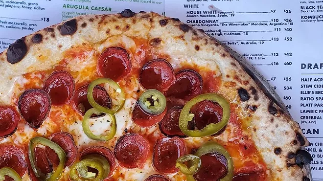 pizza with pepperoni on placemat