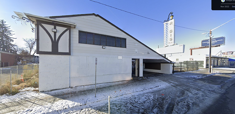 Image: A white building sits in front of a dilapidated sign that says "RGIS".