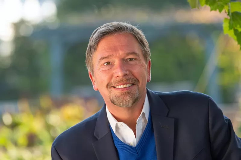 Image: man with beard in blue jacket, white shirt