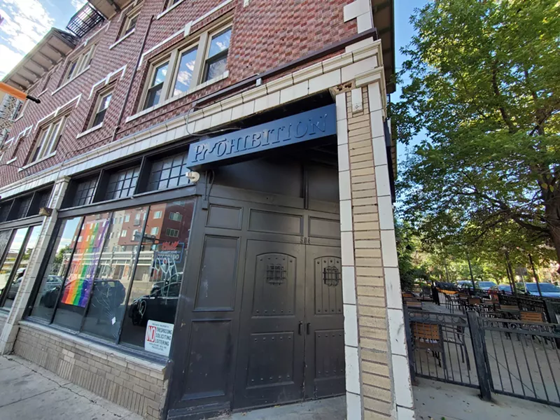 Image: a brick building with a black doorway