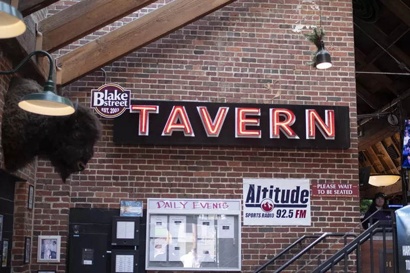 Image: a "Tavern" sign inside a bar
