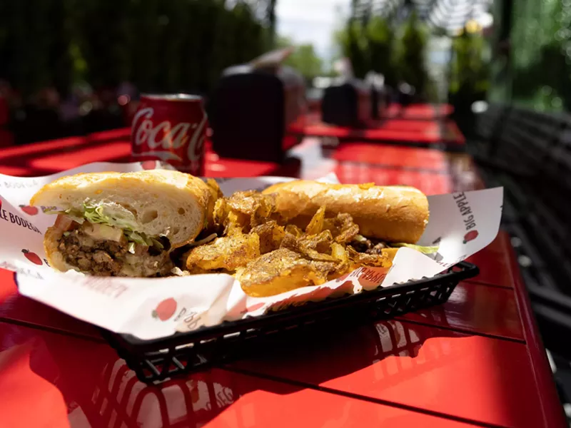 Image: a sandwich and fries on a red table