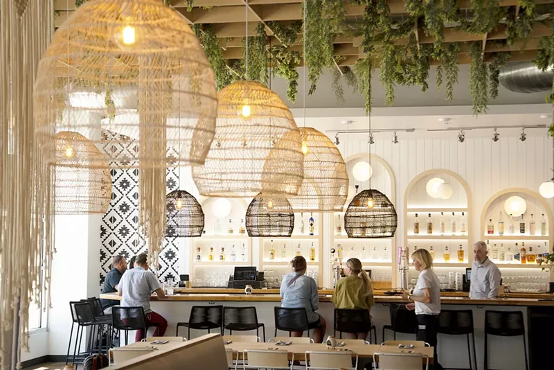 Image: interior of a restaurant with macrame light fixtures