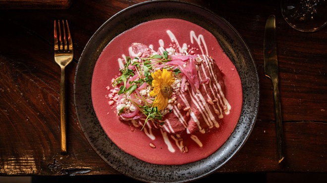 a dish with pink sauce on a black plate