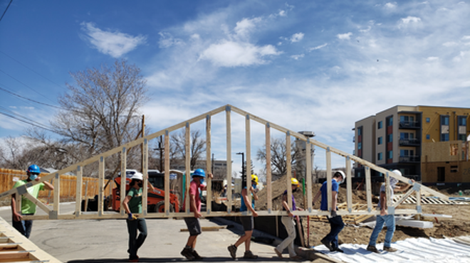 workers carrying part of houses