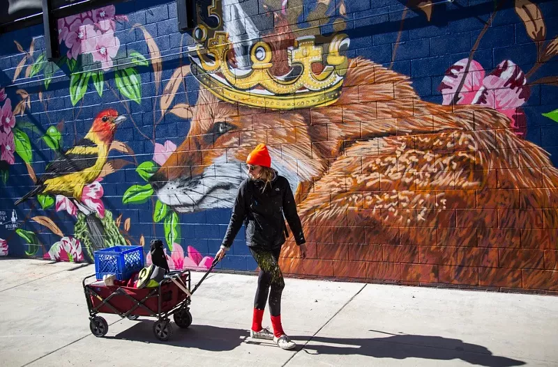 Image: Alexandrea Pangburn painting her mural on a wall by Number Thirty Eight.