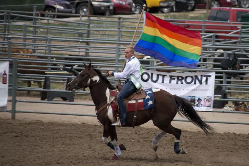 Image: rodeo rider with gay flag