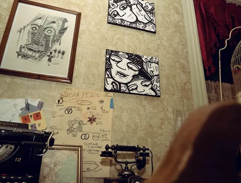 Image: Black and white paintings on the wall of an old mansion