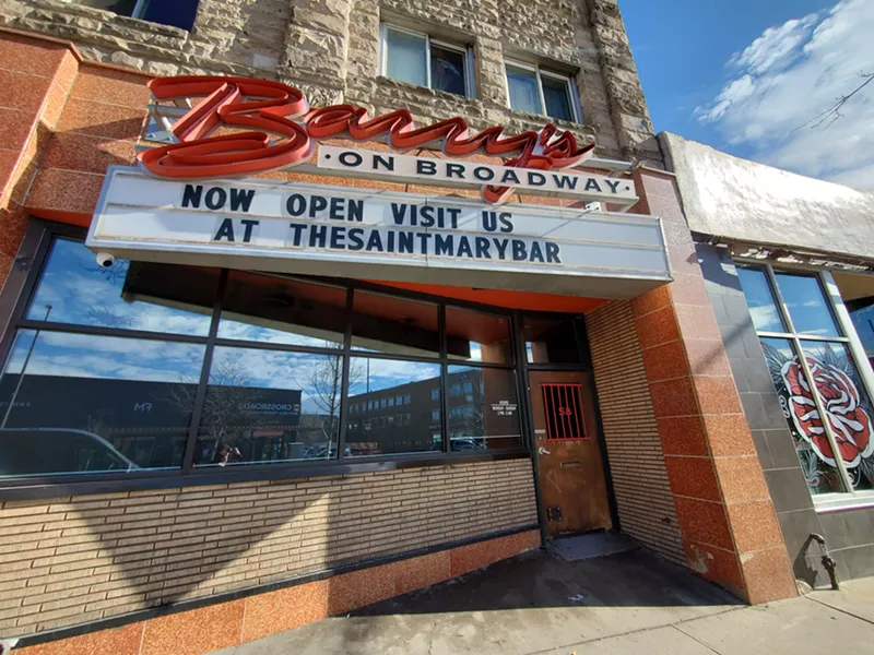 Image: a retro sign with a marquee outside of a bar