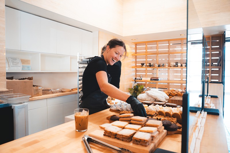 Anna Nguyen arranges the pastry case at the Bakehouse.
