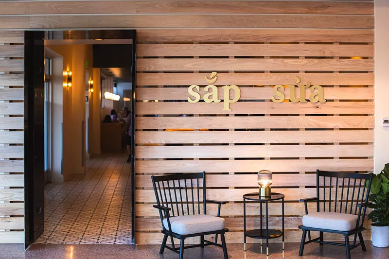Image: two chairs in front of a wooden wall next to an open entryway