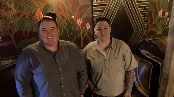 Ashlee Cassity and Dom Garcia standing inside their bar, Pearl Divers