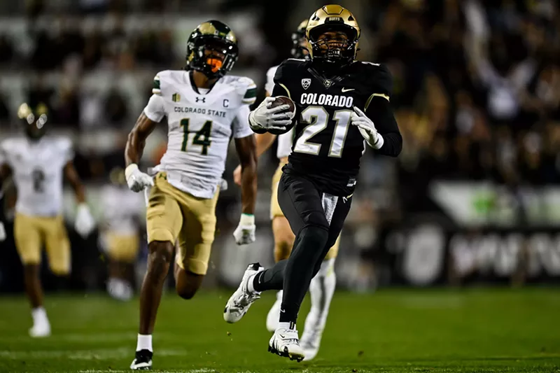 Image: CU football player Shilo Sanders runs back an interception against CSU